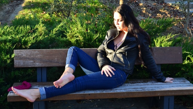 Flirty Diana teasing you with her sexy feet in the park
