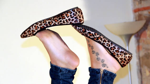 Gorgeous Valeria dangling her leopard-print ballet flats from her toes